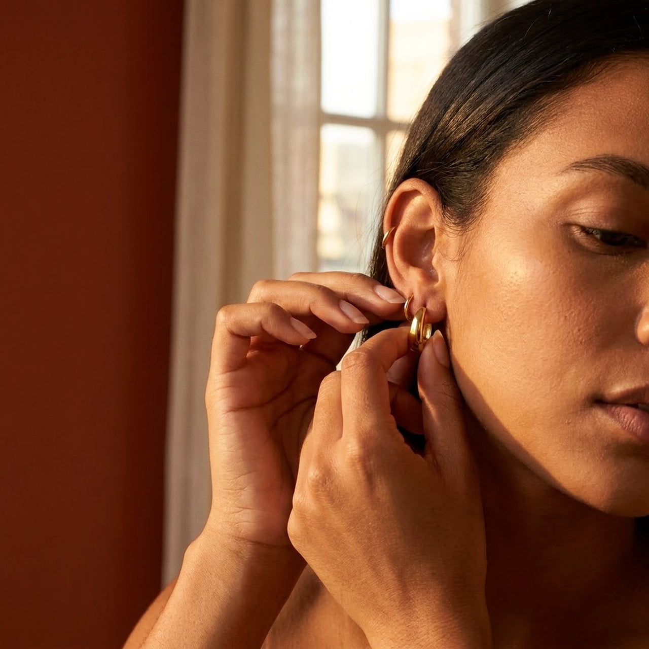 Chunky Dome Hoops in Gold, being put on | SKU: 41005-gold