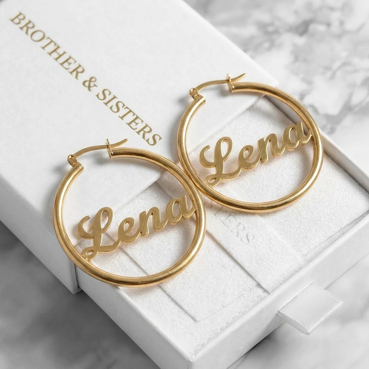 Custom Name Hoop Earrings in Gold in the Brother & Sisters gift box | SKU: name-hoop-gold-30-mm
