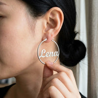 Thumbnail for Custom Name Hoop Earrings in Silver held between the fingertips, scale reference | SKU: name-hoop-silver-30-mm