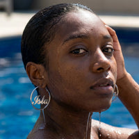 Thumbnail for Custom Name Hoop Earrings in Silver worn in a swimming pool, waterproof 304L stainless steel | SKU: name-hoop-silver-30-mm