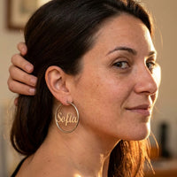 Thumbnail for Custom Name Hoop Earrings in Silver worn on the ear, close-up on a model | SKU: name-hoop-silver-30-mm