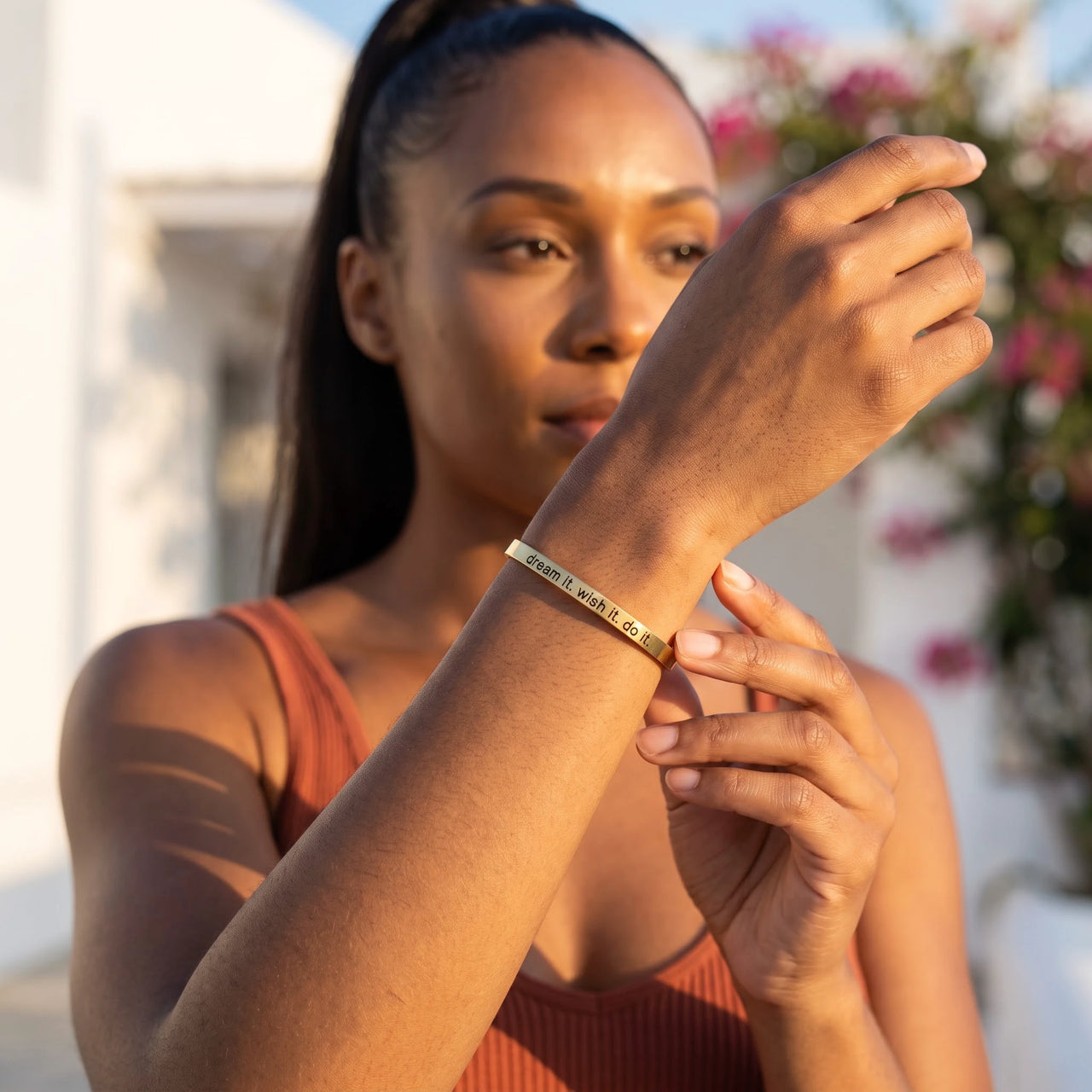 Woman gently touching her gold engraved cuff bracelet | SKU: 4214557-gold-color