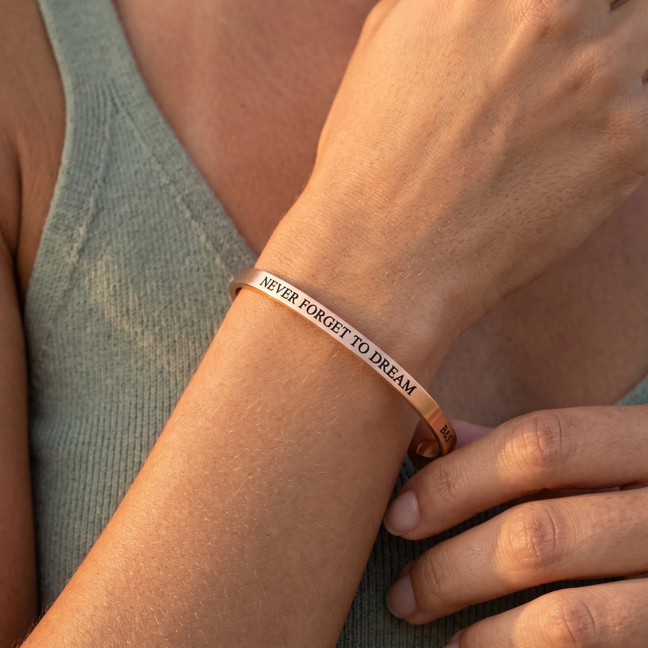 Close-up of the Never Forget To Dream bracelet in rose gold worn | SKU: nftd-rg