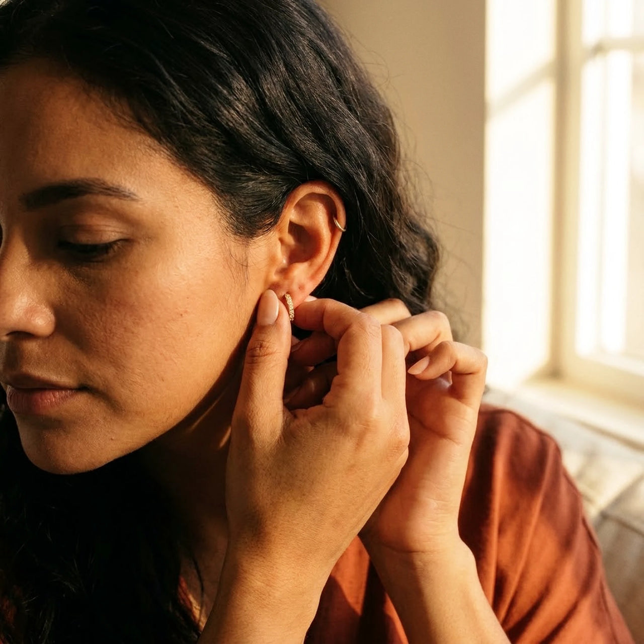 Pave Huggie Hoop Earrings in Gold, being put on | SKU: 41011-gold