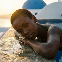 Thumbnail for Pave Huggie Hoop Earrings in Gold, worn by a pool in Santorini | SKU: 41011-gold