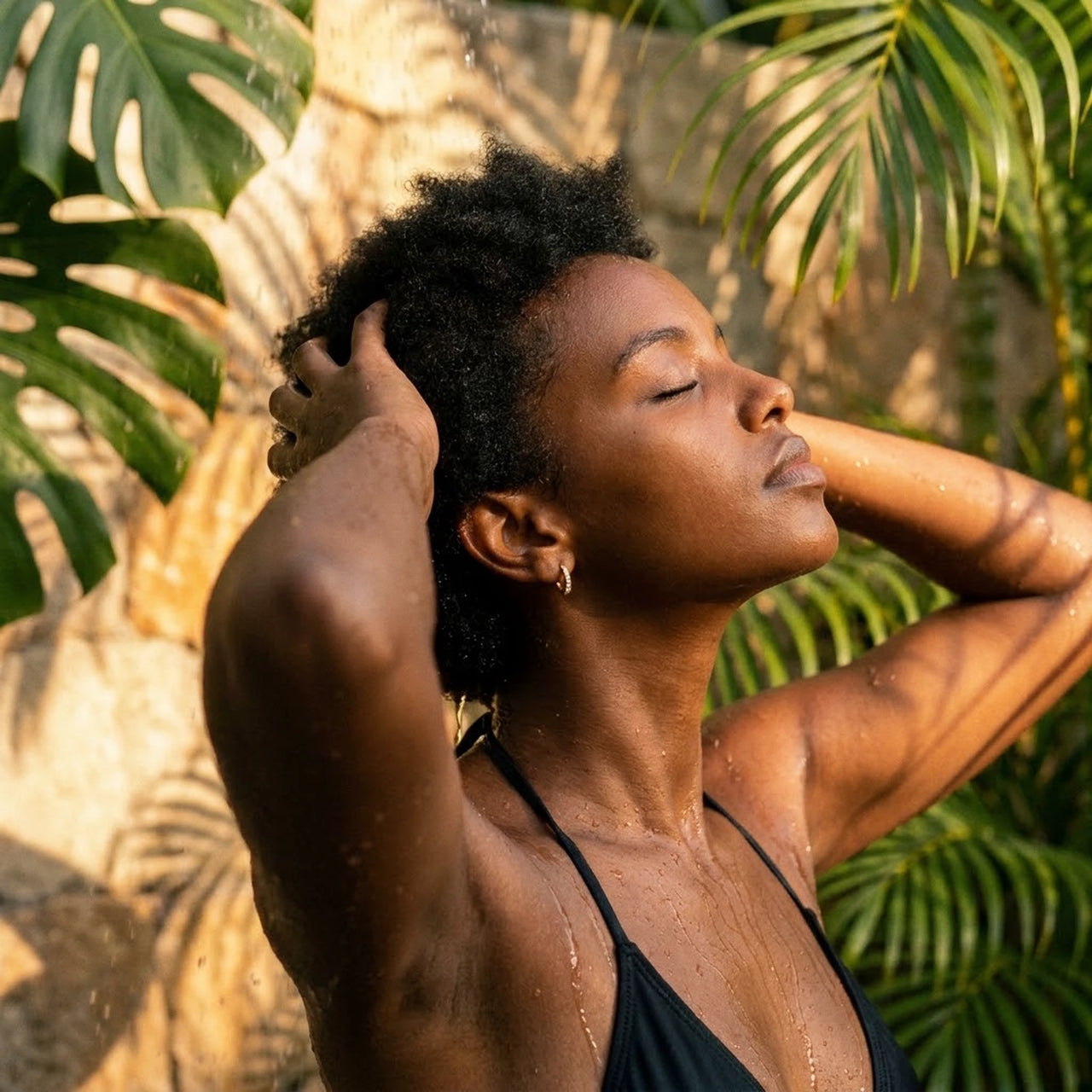 Pave Huggie Hoop Earrings in Gold, worn in a tropical outdoor shower | SKU: 41011-gold