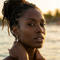 Thumbnail for Pearl Drop Huggie Hoops in Gold, worn in the sea, wet skin | SKU: 41003-gold
