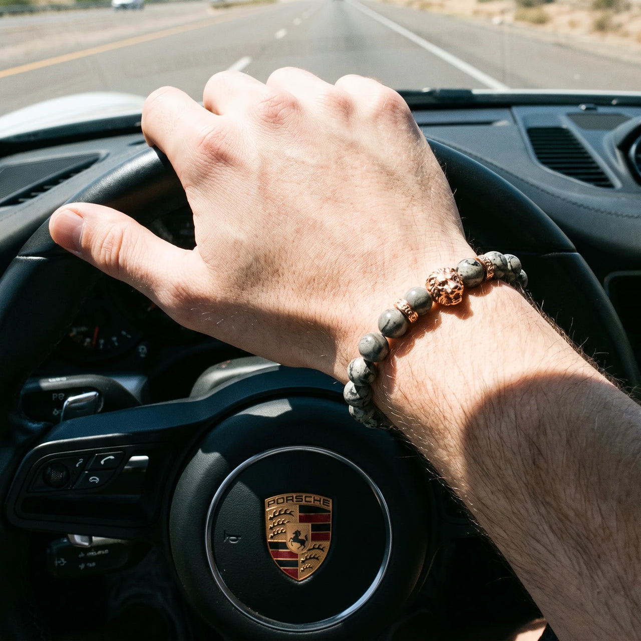 Rose Gold Lion & Grey Stones Bracelet – worn at the steering wheel of a luxury car | Brother & Sisters | SKU: 20866222-rose-gold-XS-14-15, 20866222-rose-gold-S-16-17, 20866222-rose-gold-M-18-19, 20866222-rose-gold-L-20-21, 20866222-rose-gold-XL-22-23