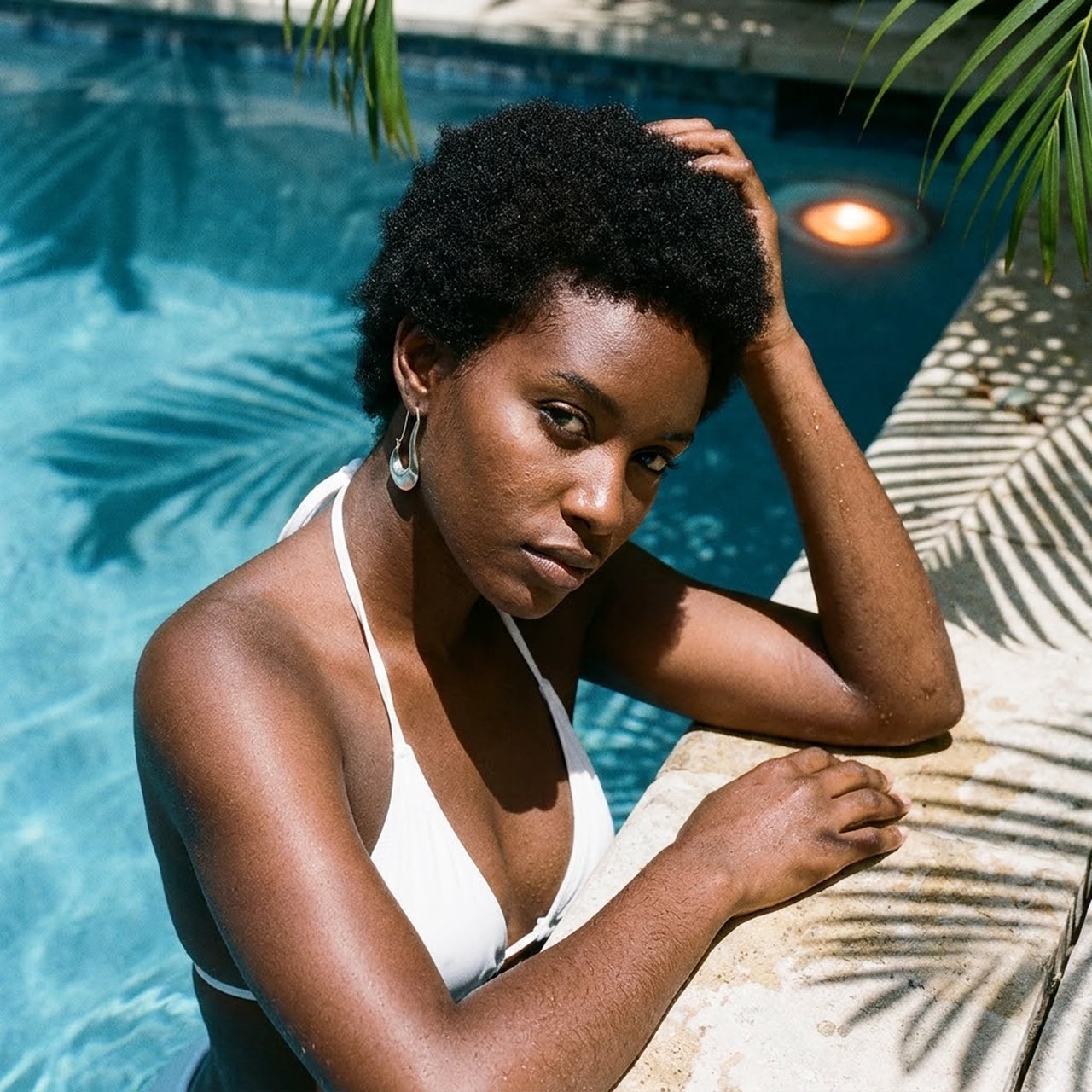 Sculpted Crescent Drops in Silver, worn by a tropical pool | SKU: 41008-silver