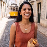Thumbnail for Woman in a Lisbon street wearing the gold secret heart photo necklace | SKU: TPH-CHTN-GOLD-SMALL