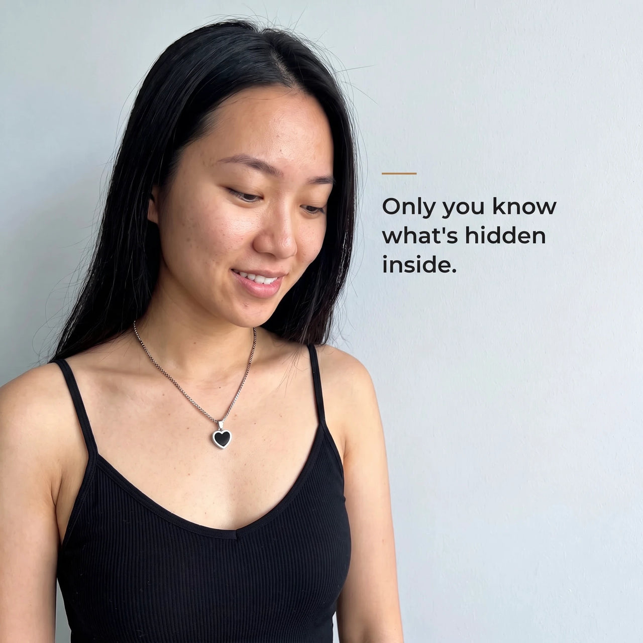 Woman wearing the silver heart pendant, black on the outside, only she knows the photo inside | SKU: TPH-CHTN-SILVER-SMALL