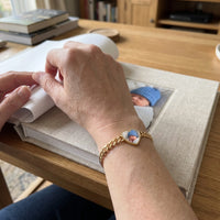 Thumbnail for The gold heart photo bracelet on her wrist, showing its real small size | SKU: TPH-HRTB-GOLD