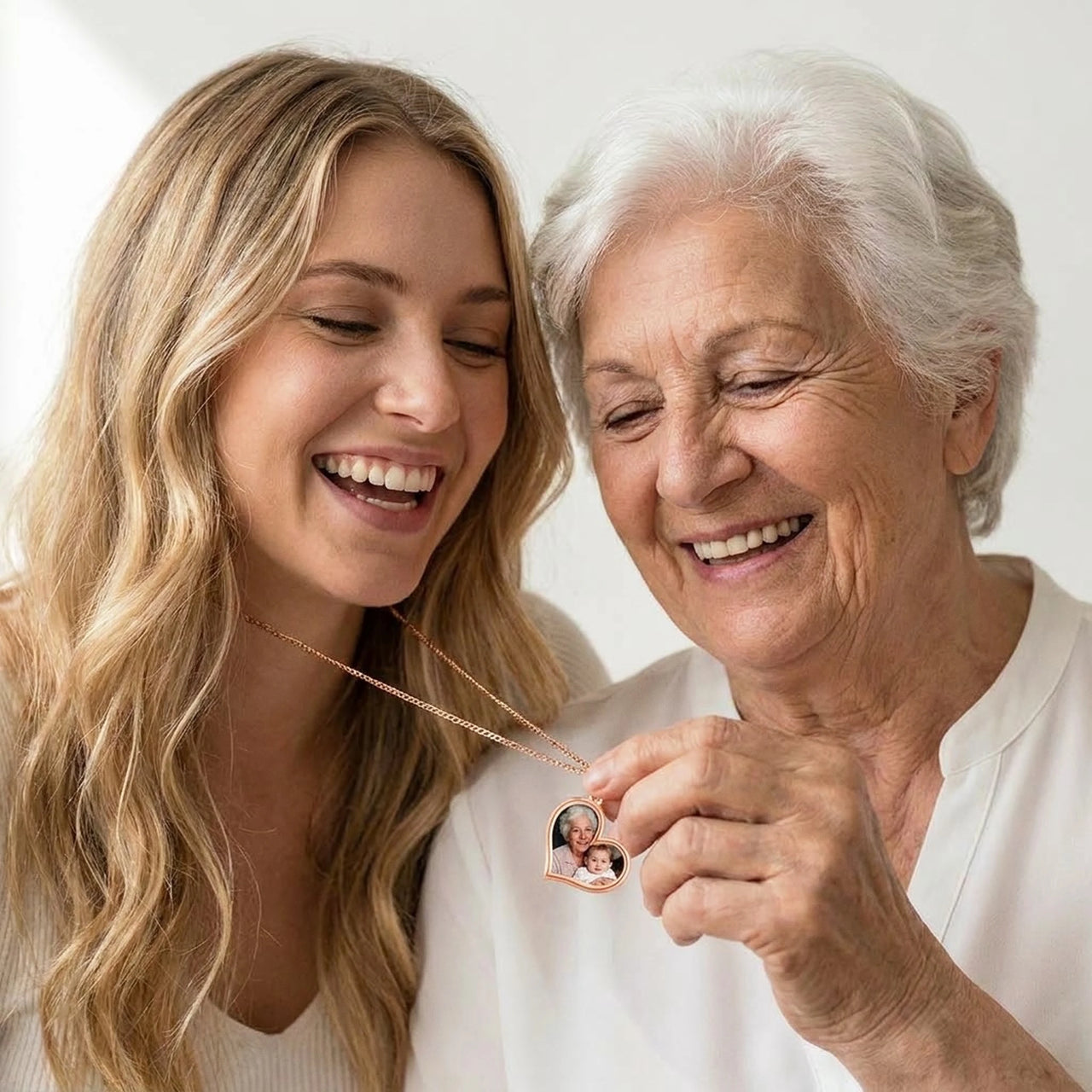Grandmother and granddaughter laughing over the photo in the rose gold heart necklace | SKU: TPH-HRTN-ROSEGOLD
