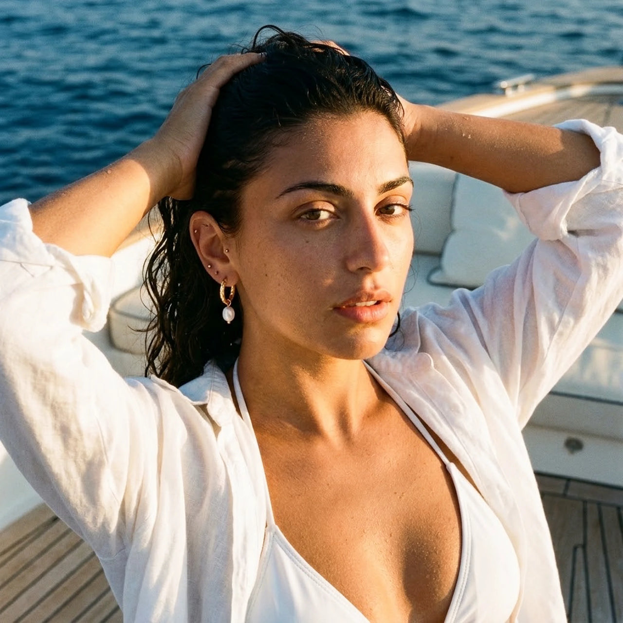 Twisted Pearl Drop Hoops in Gold, worn on a yacht | SKU: 41004-gold